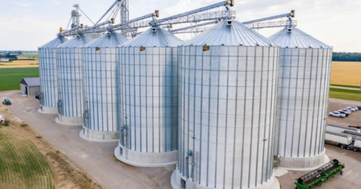 Large metal grain silos at commercial agricultural storage facility