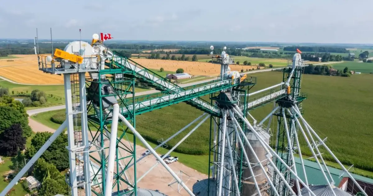 Grain elevator conveyors and material handling system overlooking farmland